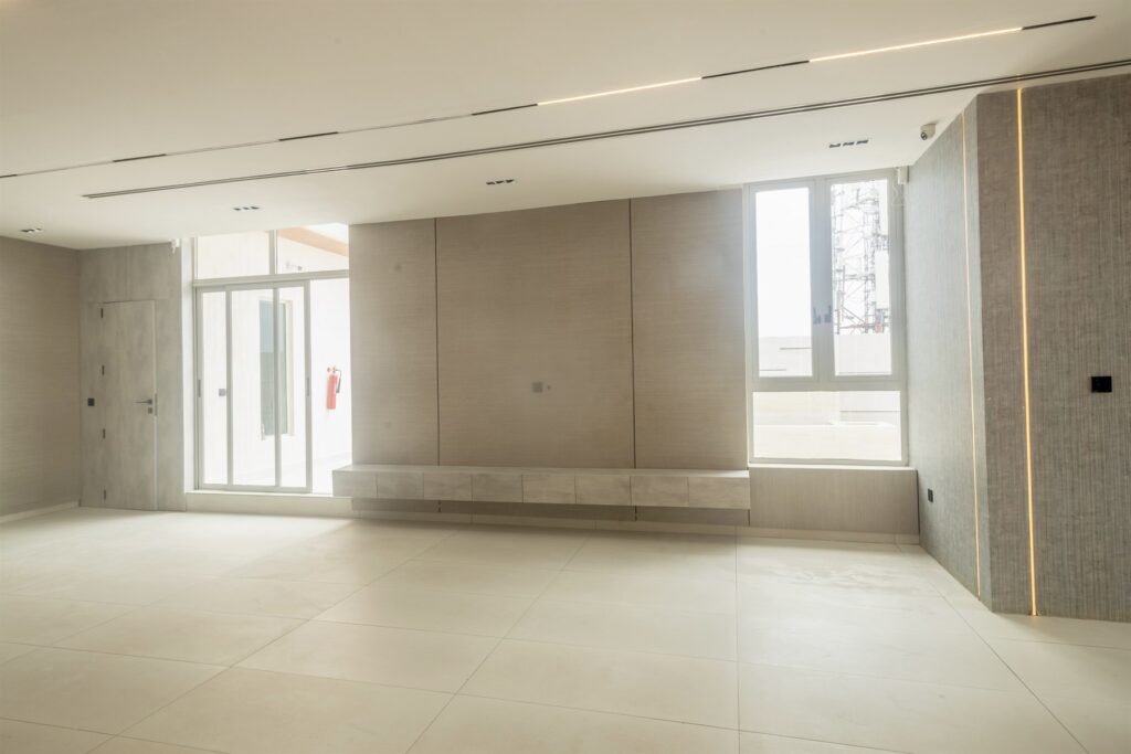 Brum Height 6: Unfurnished living room beside sliding balcony doors